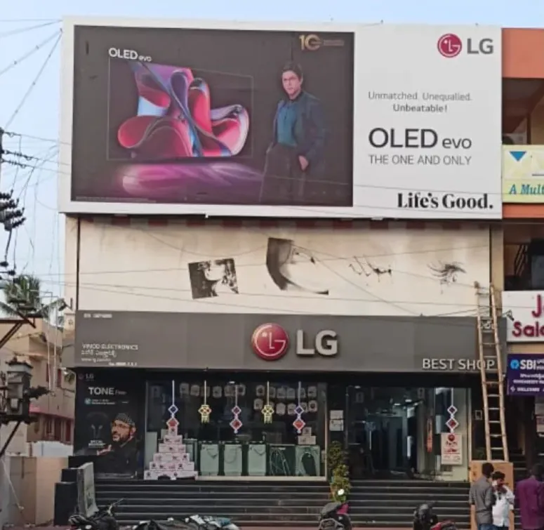 LG OLED evo building hoarding above a Tirupati electronics showroom